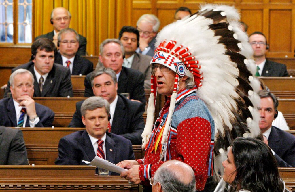 Canadian Prime Minister Stephen Harper and other members of Parliament listen as National Chief of the Assembly of First Nations Phil Fontaine speaks in the House of Commons on Parliament Hill in Ottawa, June 11, 2008.