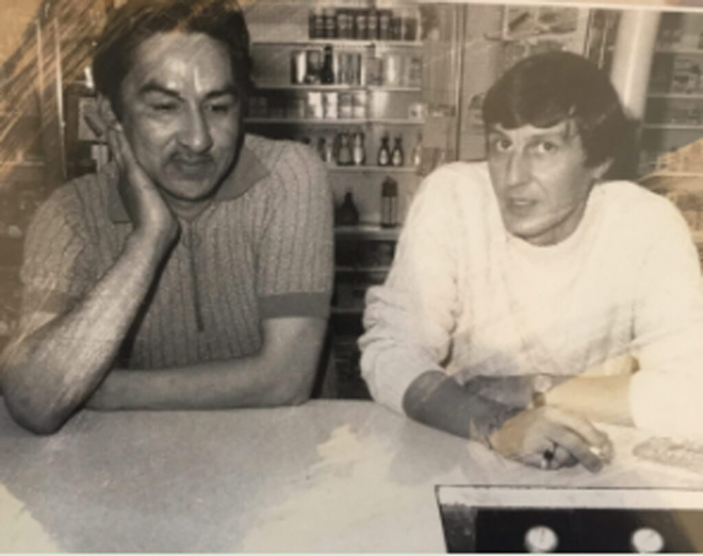 black and white photo of Jack Pollock and Norval Morrisseau at a table