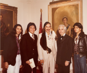 norval morrisseau standing in the centre of five people at the order of canada